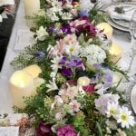 Floral table runner whose sides cascade to the floor