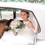 Bride in the car with flowers.jpg