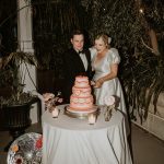 couple wedding cake cutting three tier pink