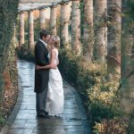 Bride and groom in pergola walk at Marden Park mansion gardens, Surrey