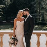 Bride and groom on steps of mansion at Marden Park, Surrey