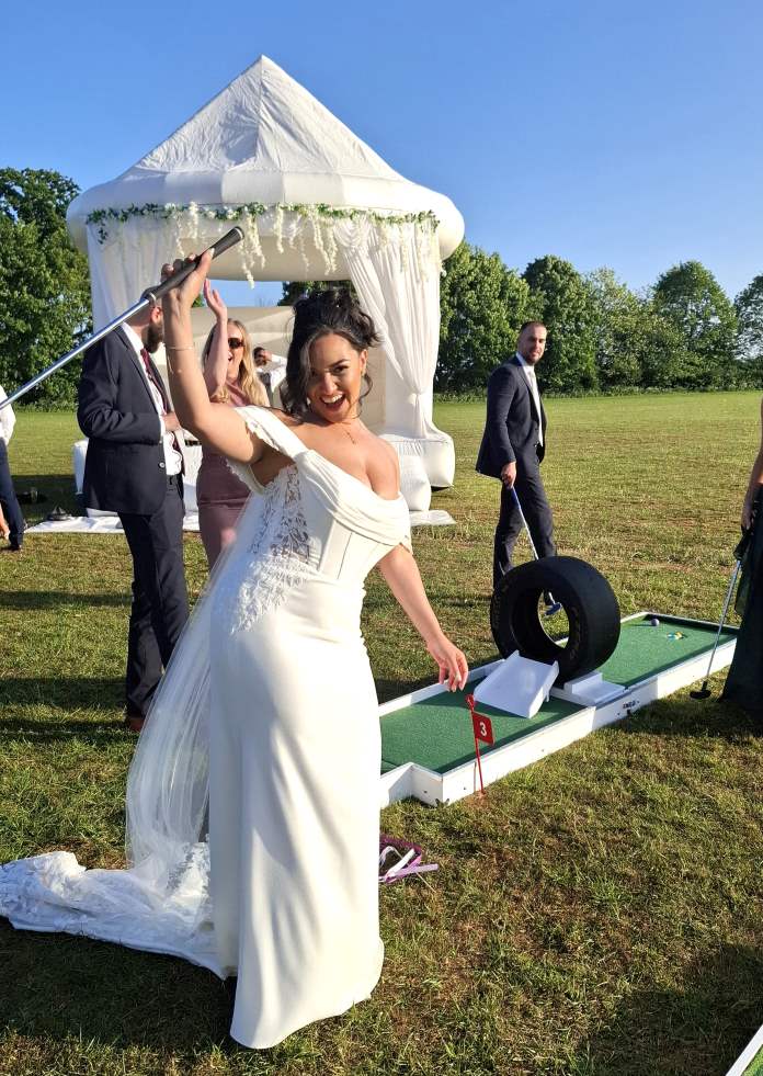 Bride playing puttputtgolf mini golf a