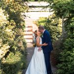 Wedding kiss in pergola walk